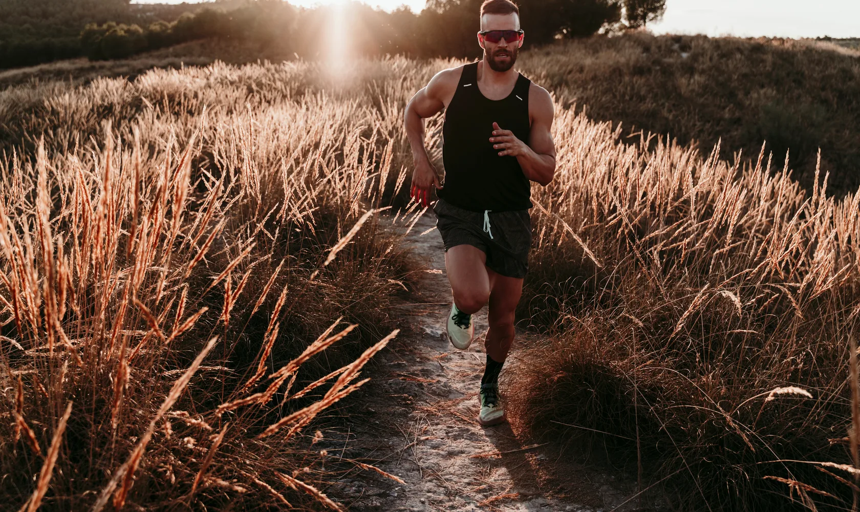 An athlete sprinting at sunrise