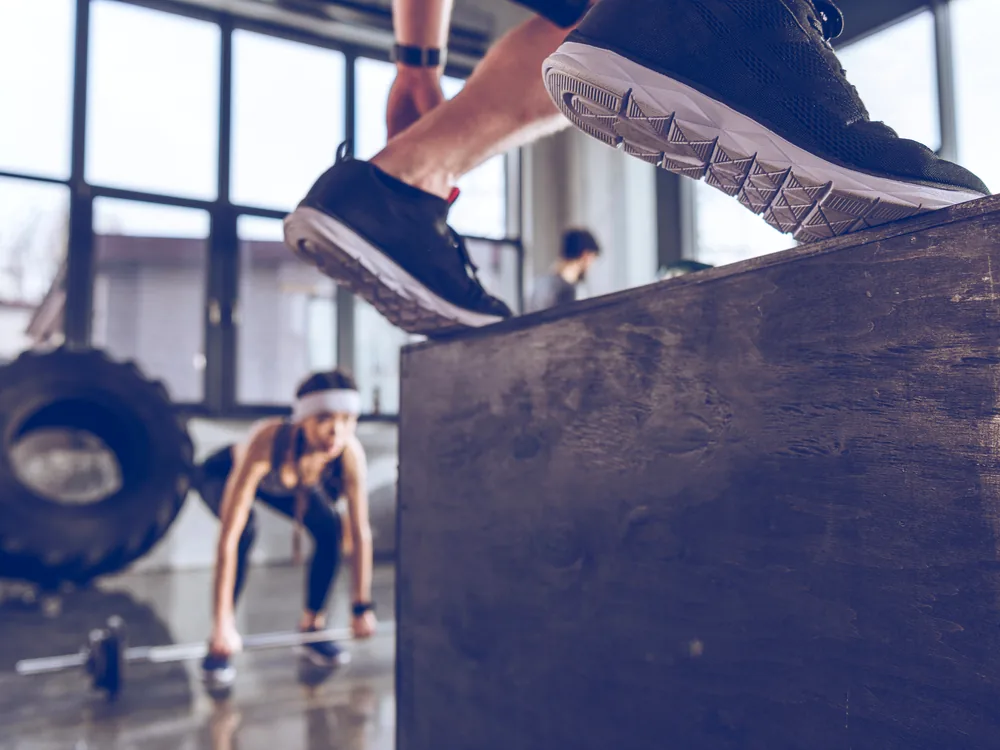 An athlete performing an explosive box jump
