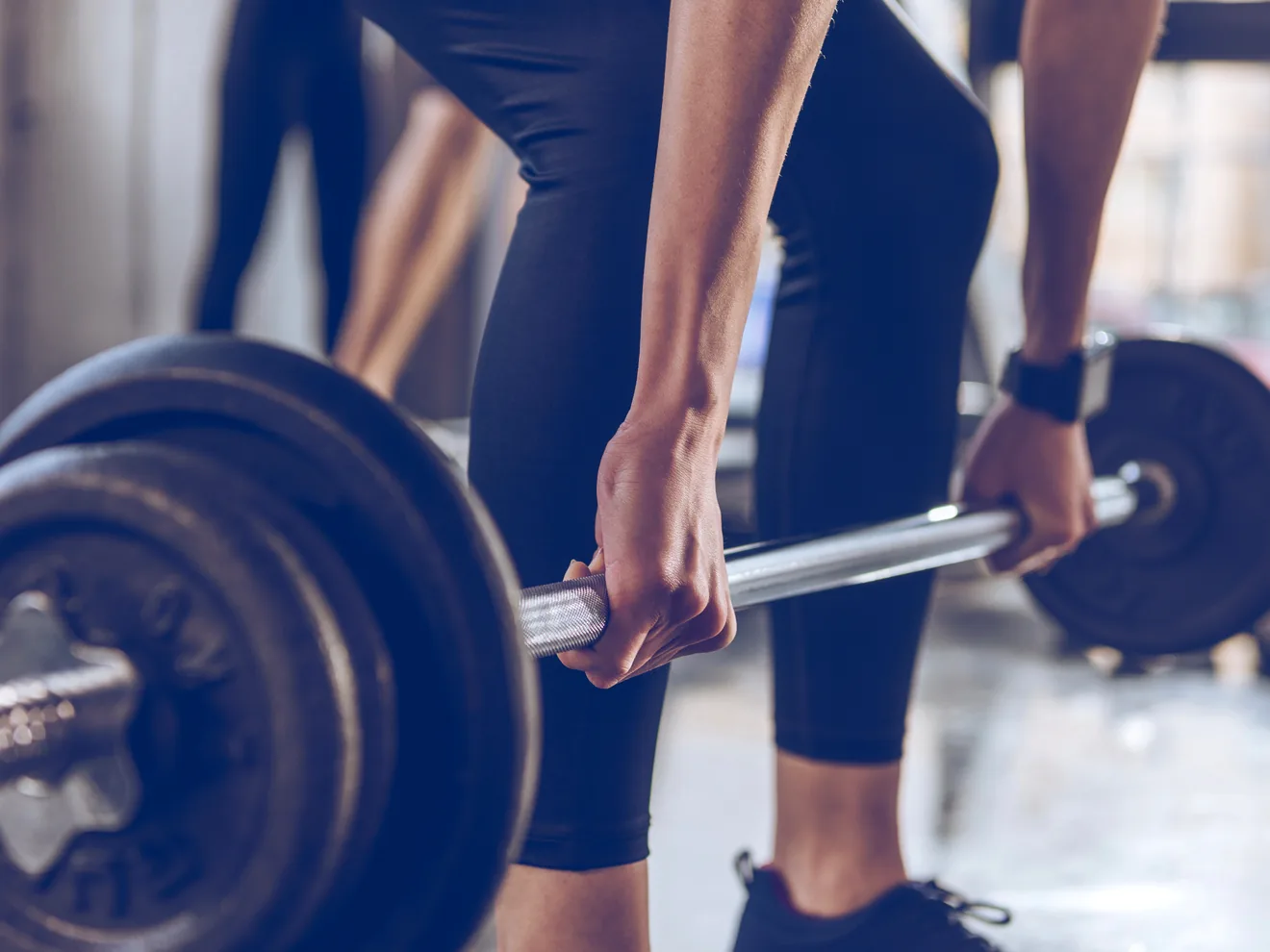 Close-up of an athlete gripping a loaded barbell